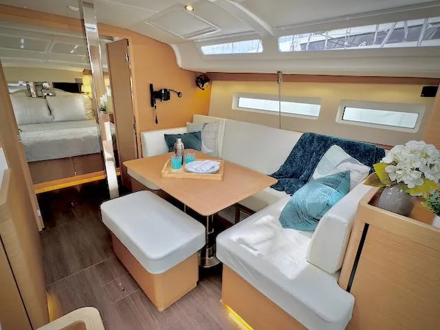 In Stock 440 #442 Yacht Photos Pics Luxurious interior of 2023 Jeanneau Sun Odyssey 440 sailboat with cozy seating and modern decor.