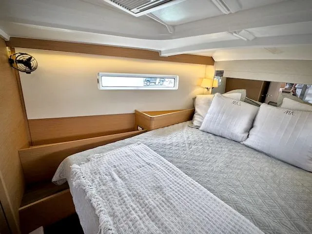 In Stock 440 #442 Yacht Photos Pics Luxurious cabin interior of 2023 Jeanneau Sun Odyssey 440 yacht, featuring cozy bedding and modern design.