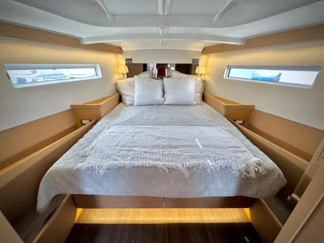 In Stock 440 #442 Yacht Photos Pics Luxurious cabin interior of 2023 Jeanneau Sun Odyssey 440 yacht with cozy bedding.