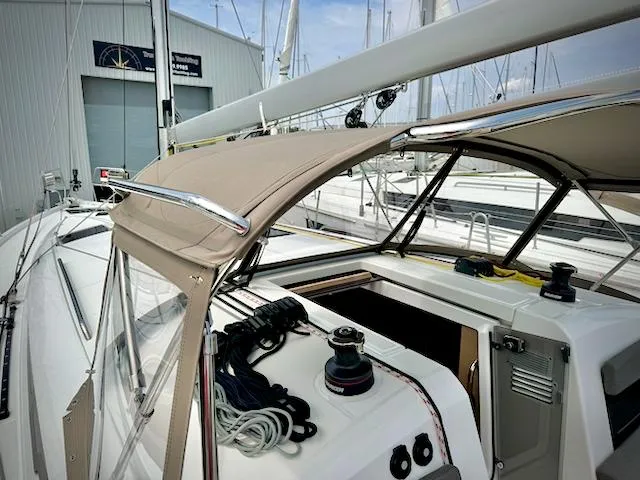 In Stock 440 #442 Yacht Photos Pics 2023 Jeanneau Sun Odyssey 440 sailboat cockpit with ropes and winch, docked at marina.
