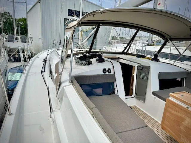 In Stock 440 #442 Yacht Photos Pics 2023 Jeanneau Sun Odyssey 440 sailboat cockpit with canopy and seating area.