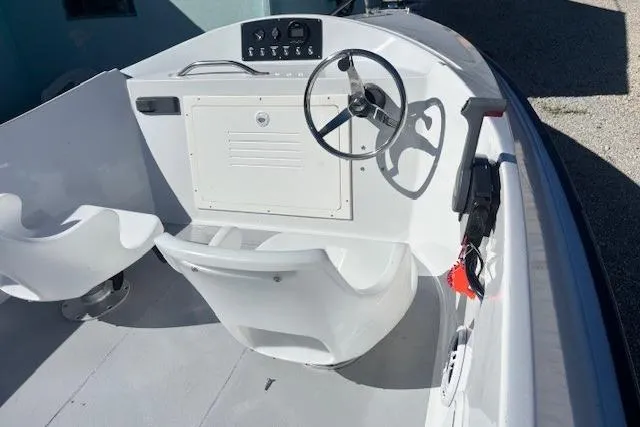 1985 JJM VS boat interior with steering wheel and seating, showcasing classic design.