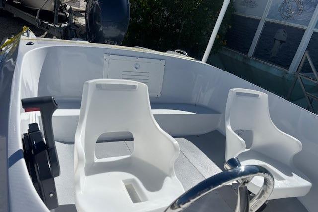 1985 JJM VS boat interior with white seats and steering wheel.