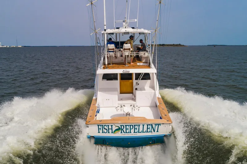 Fish Repellent Yacht Photos Pics Jarrett Bay 54 Convertible 2000 yacht cruising on open water, rear view.