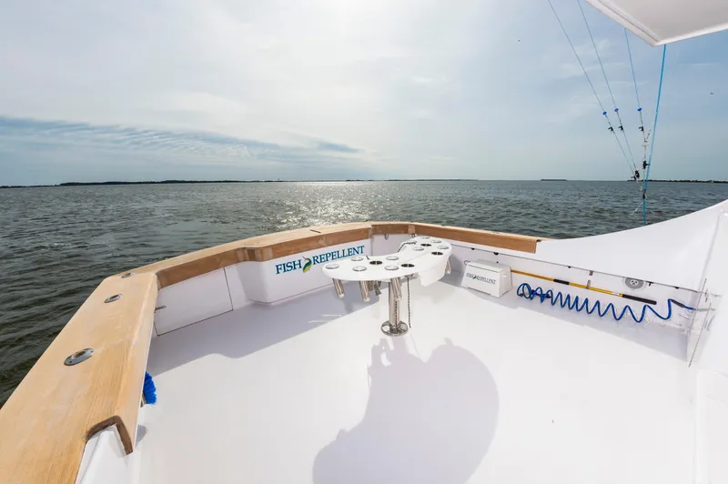 Fish Repellent Yacht Photos Pics Jarrett Bay 54 Convertible 2000 yacht deck with fishing equipment, ocean view.