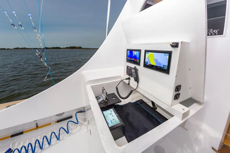 Fish Repellent Yacht Photos Pics Jarrett Bay 54 Convertible 2000 boat cockpit with navigation screens and fishing equipment.