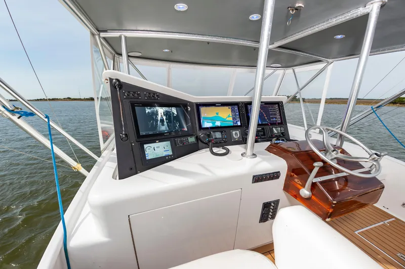 Fish Repellent Yacht Photos Pics Jarrett Bay 54 Convertible 2000 yacht helm with navigation screens and steering wheel.