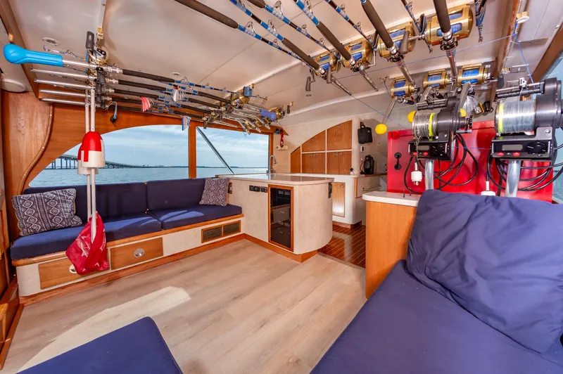 Fish Repellent Yacht Photos Pics Interior of 2000 Jarrett Bay 54 Convertible yacht with fishing rods and cozy seating.