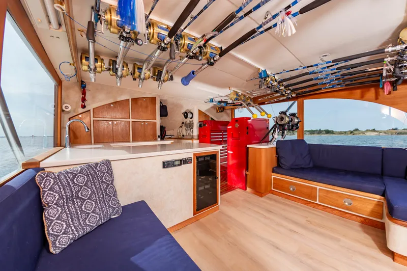 Fish Repellent Yacht Photos Pics Interior of 2000 Jarrett Bay 54 Convertible yacht with fishing rods and seating area.