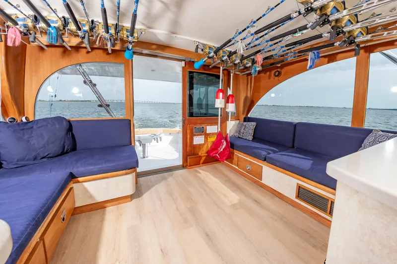 Fish Repellent Yacht Photos Pics Interior of 2000 Jarrett Bay 54 Convertible yacht with blue seating and fishing rods.