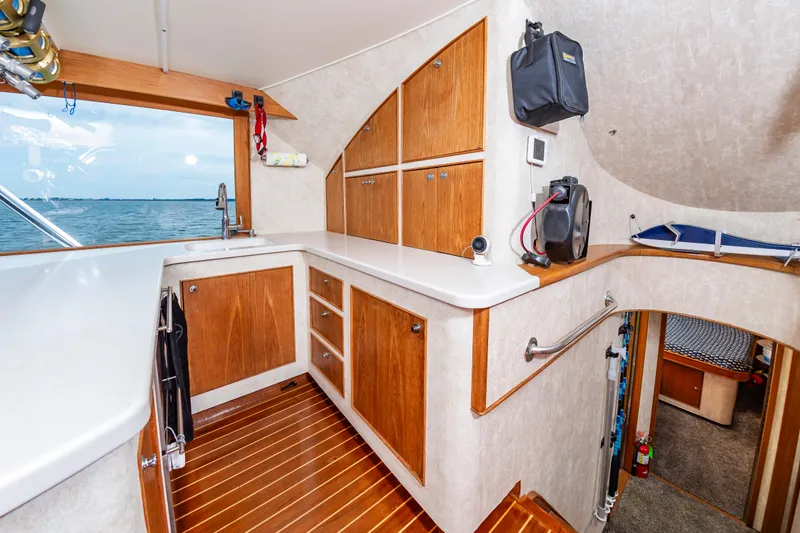 Fish Repellent Yacht Photos Pics Interior of 2000 Jarrett Bay 54 Convertible yacht with wooden cabinetry and ocean view.