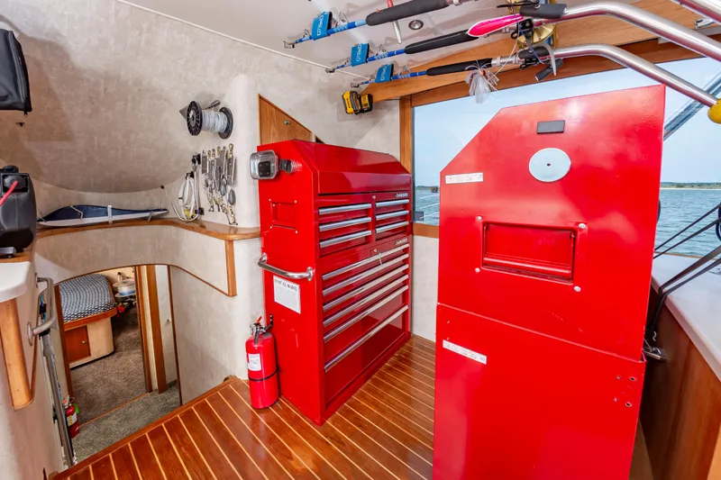 Fish Repellent Yacht Photos Pics Interior of 2000 Jarrett Bay 54 Convertible with red tool chest and fishing gear.