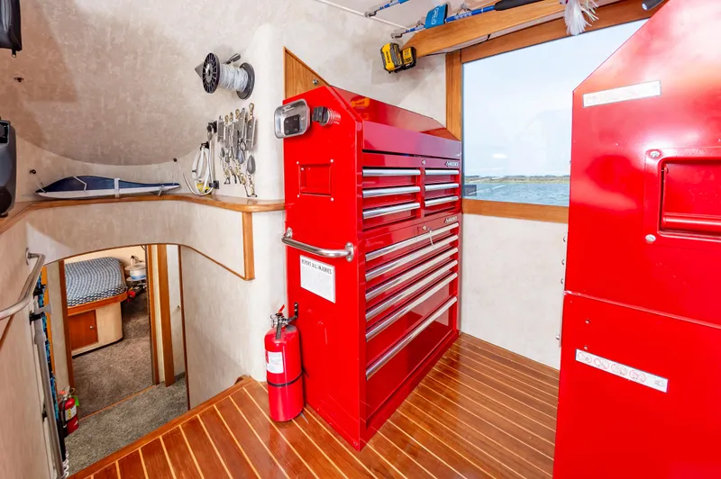 Fish Repellent Yacht Photos Pics Interior of 2000 Jarrett Bay 54 Convertible with red tool cabinets and ocean view.