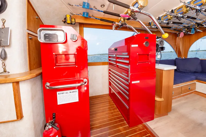 Fish Repellent Yacht Photos Pics Interior of 2000 Jarrett Bay 54 Convertible with red tool cabinets and fishing rods.