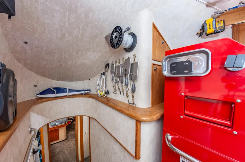 Fish Repellent Yacht Photos Pics Interior of 2000 Jarrett Bay 54 Convertible with fishing gear and red storage unit.