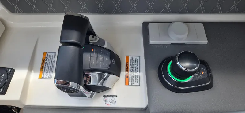  Yacht Photos Pics Control panel of 2021 Sea Ray SLX 310 Outboard with joystick and throttle controls.