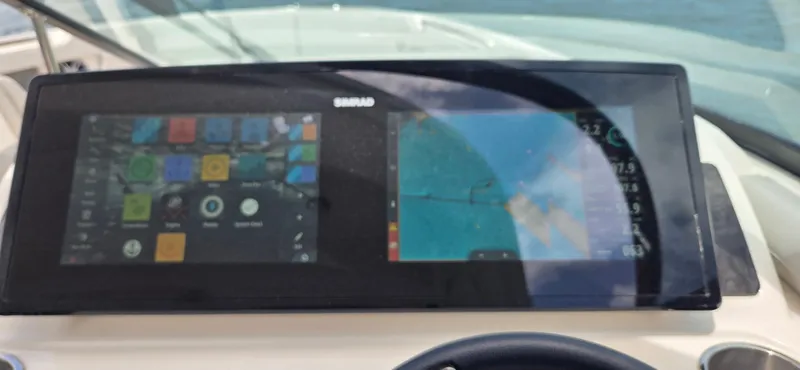  Yacht Photos Pics Dashboard of 2021 Sea Ray SLX 310 Outboard with navigation and control screens.