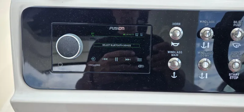  Yacht Photos Pics Control panel of 2021 Sea Ray SLX 310 Outboard with Fusion audio system and various buttons.