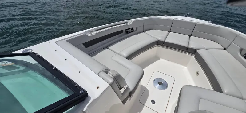  Yacht Photos Pics 2021 Sea Ray SLX 310 Outboard boat with spacious seating and sleek design on the water.