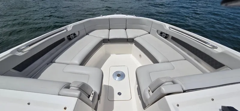  Yacht Photos Pics 2021 Sea Ray SLX 310 Outboard boat with spacious seating on calm water.