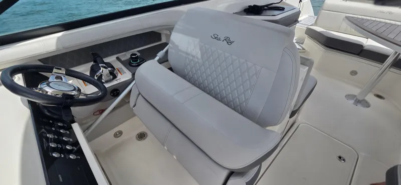  Yacht Photos Pics 2021 Sea Ray SLX 310 Outboard interior with steering wheel and seating.