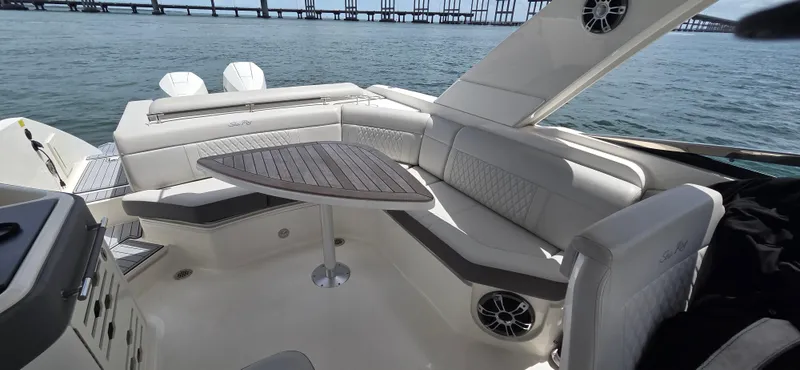  Yacht Photos Pics 2021 Sea Ray SLX 310 Outboard boat interior with seating and table on the water.