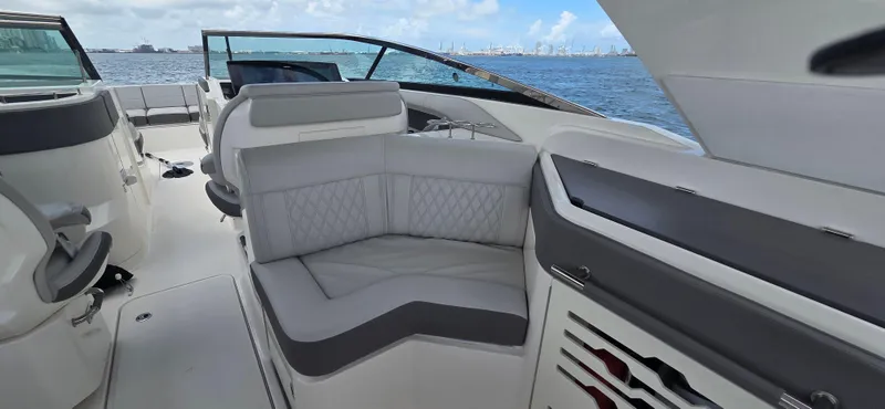  Yacht Photos Pics Luxurious seating on 2021 Sea Ray SLX 310 Outboard, with ocean view in background.