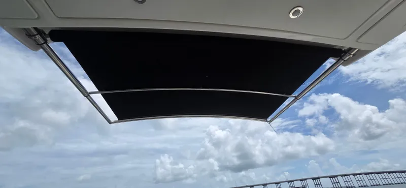  Yacht Photos Pics 2021 Sea Ray SLX 310 Outboard boat canopy against a cloudy sky.