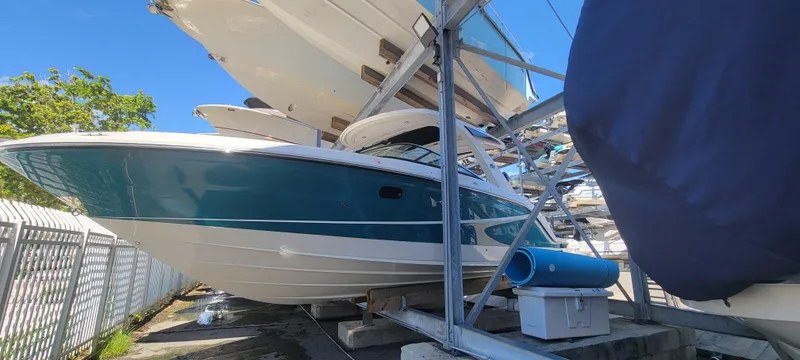  Yacht Photos Pics 2021 Sea Ray SLX 310 Outboard boat in storage, blue hull, sunny day.