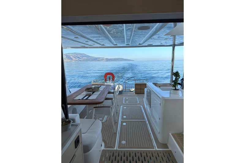 Echoes 1 Yacht Photos Pics Luxurious 2023 Lagoon 55 yacht interior with ocean view and elegant dining area.