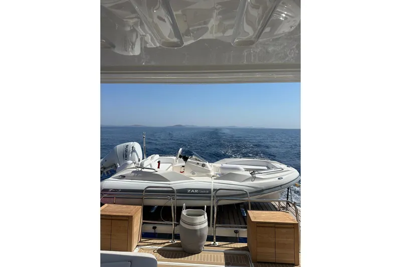 Echoes 1 Yacht Photos Pics 2023 Lagoon 55 yacht with tender on deck, cruising on open sea.