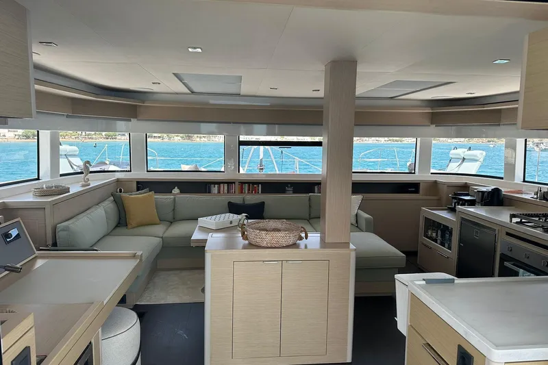 Echoes 1 Yacht Photos Pics Luxurious interior of 2023 Lagoon 55 yacht with modern kitchen and panoramic windows.