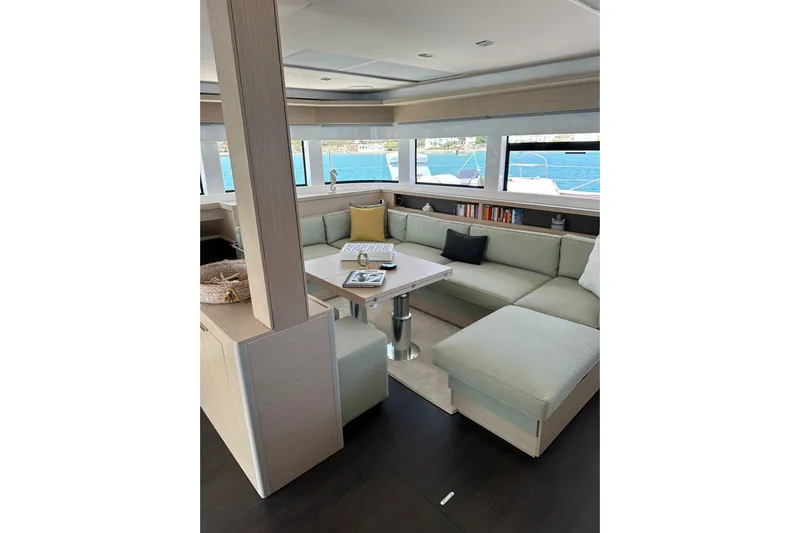 Echoes 1 Yacht Photos Pics Luxurious interior of 2023 Lagoon 55 yacht with elegant seating and ocean view.