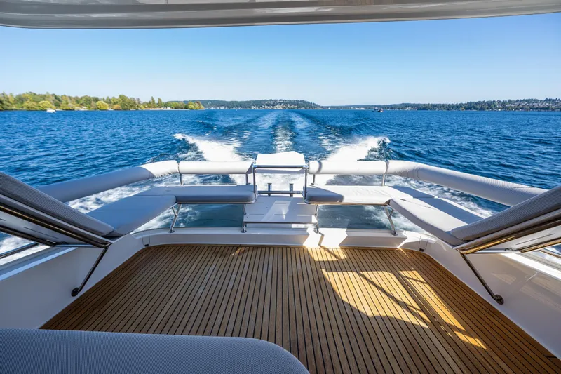 True North Yacht Photos Pics 2020 Maritimo M59 yacht cruising on a sunny day, showcasing luxurious Juliet deck and scenic water view.
