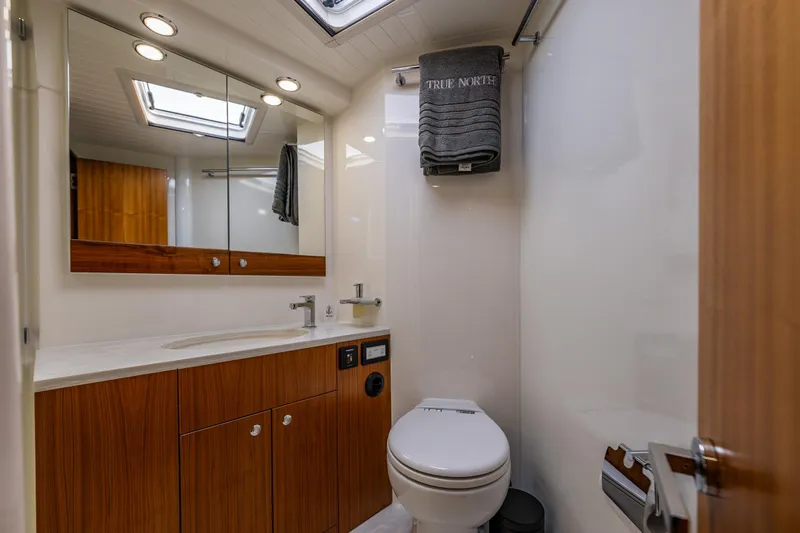 True North Yacht Photos Pics Luxurious bathroom in 2020 Maritimo M59 yacht with modern fixtures and wooden cabinetry.