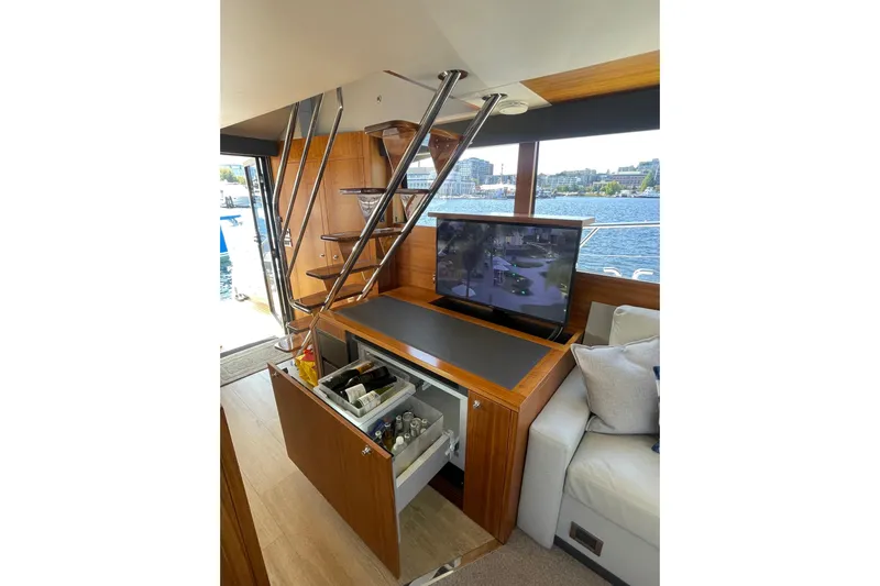 True North Yacht Photos Pics Luxurious 2020 Maritimo M59 yacht interior with TV, storage, and waterfront view.
