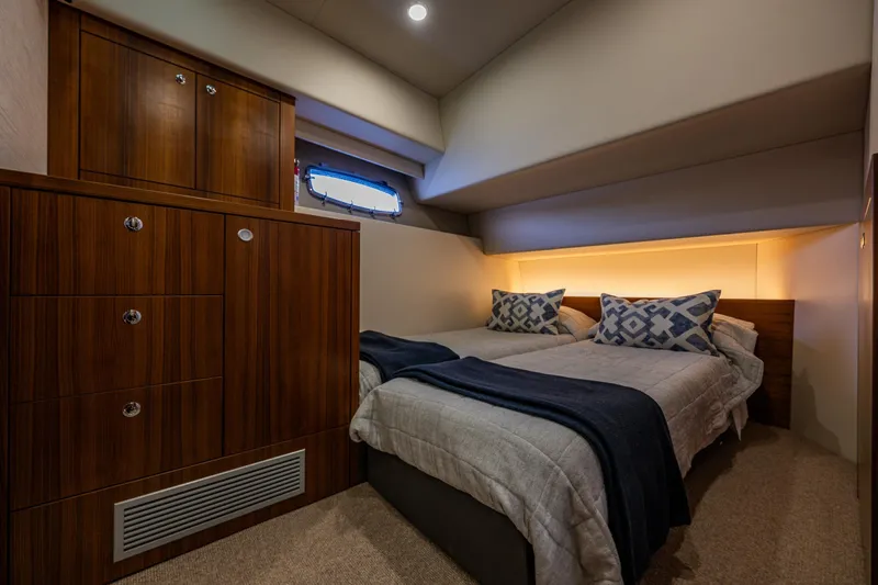 True North Yacht Photos Pics Luxurious cabin interior of 2020 Maritimo M59 yacht with cozy bedding and wooden cabinetry.