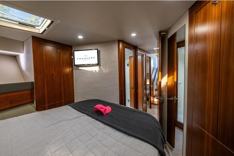 True North Yacht Photos Pics Luxurious 2020 Maritimo M59 yacht bedroom with wood accents and modern decor.