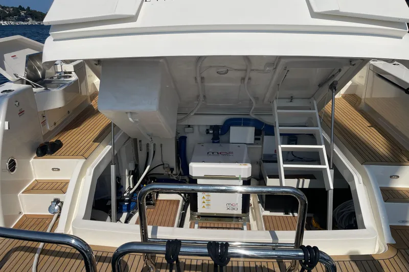 True North Yacht Photos Pics 2020 Maritimo M59 yacht engine compartment with open hatch, showcasing mechanical systems and teak decking.