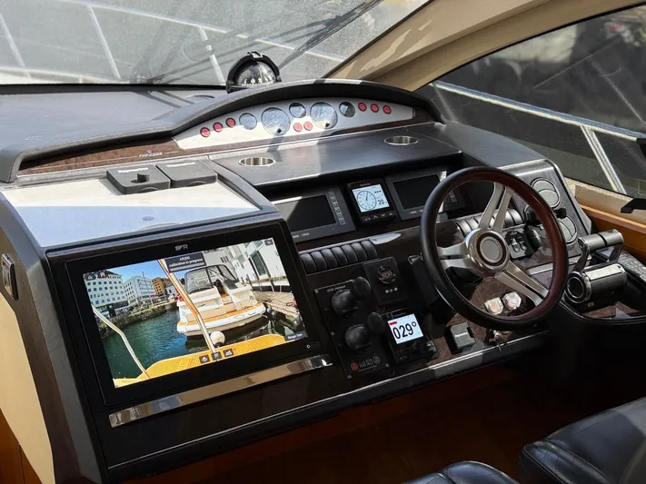  Yacht Photos Pics Dashboard of a 2009 Princess V65 yacht with navigation controls and display screen.
