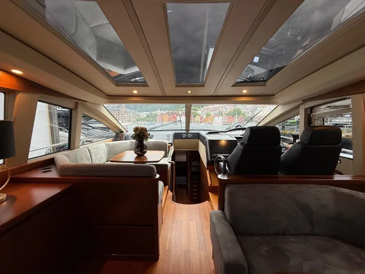 Yacht Photos Pics Luxurious interior of a 2009 Princess V65 yacht with panoramic windows and elegant seating.