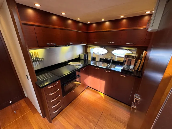  Yacht Photos Pics Luxurious kitchen interior of 2009 Princess V65 yacht with modern appliances and wood finish.