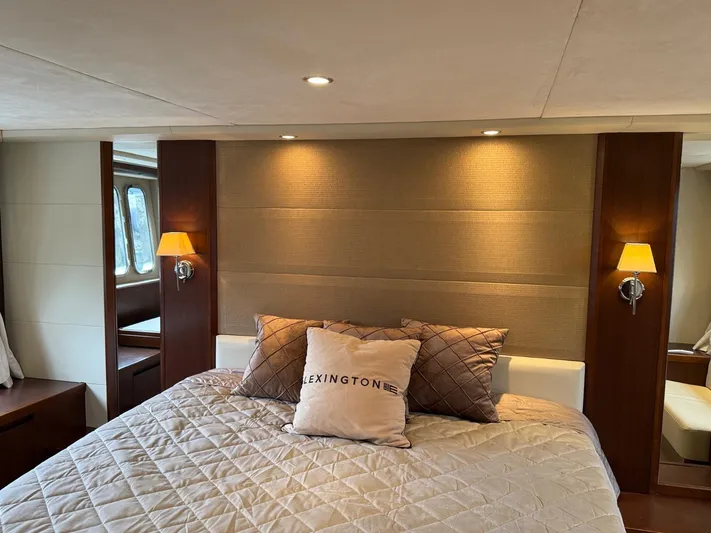  Yacht Photos Pics Luxurious bedroom interior of 2009 Princess V65 yacht with elegant bedding and ambient lighting.