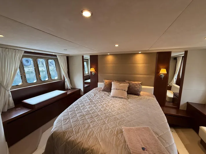  Yacht Photos Pics Luxurious bedroom interior of 2009 Princess V65 yacht with elegant decor and large windows.