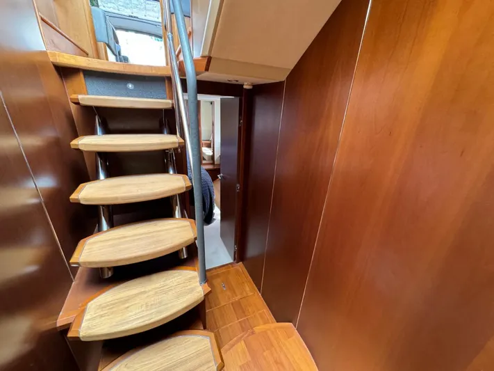  Yacht Photos Pics Interior of 2009 Princess V65 yacht with wooden stairs and sleek design.