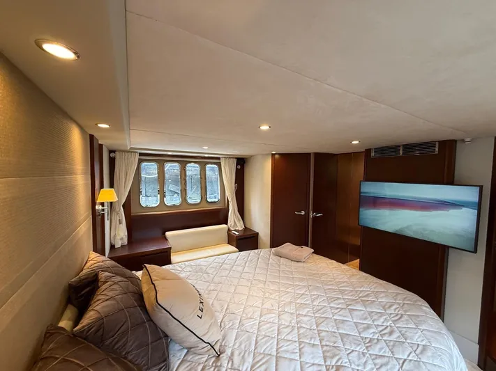  Yacht Photos Pics Luxurious bedroom interior of 2009 Princess V65 yacht with cozy bed and modern decor.