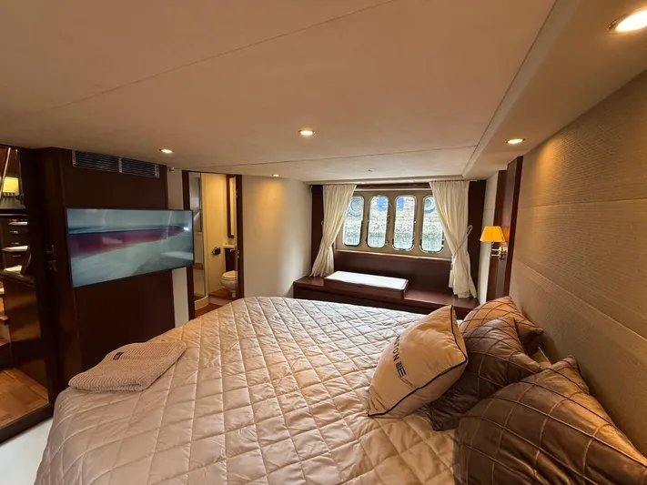  Yacht Photos Pics Luxurious bedroom interior of 2009 Princess V65 yacht with elegant decor and large windows.