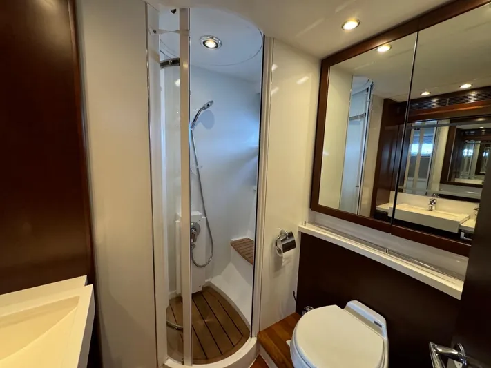  Yacht Photos Pics Luxurious bathroom in 2009 Princess V65 yacht with shower, toilet, and mirrored cabinet.