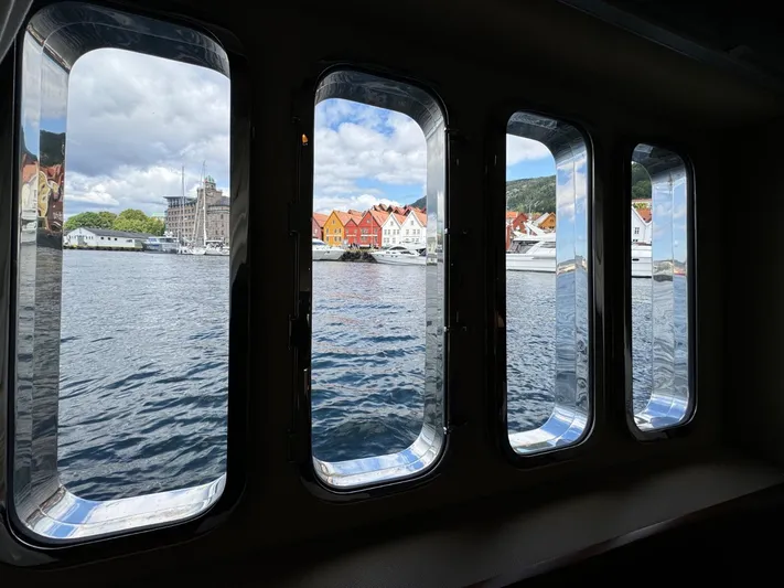  Yacht Photos Pics View through yacht windows of colorful waterfront buildings and boats, Princess V65, 2009.