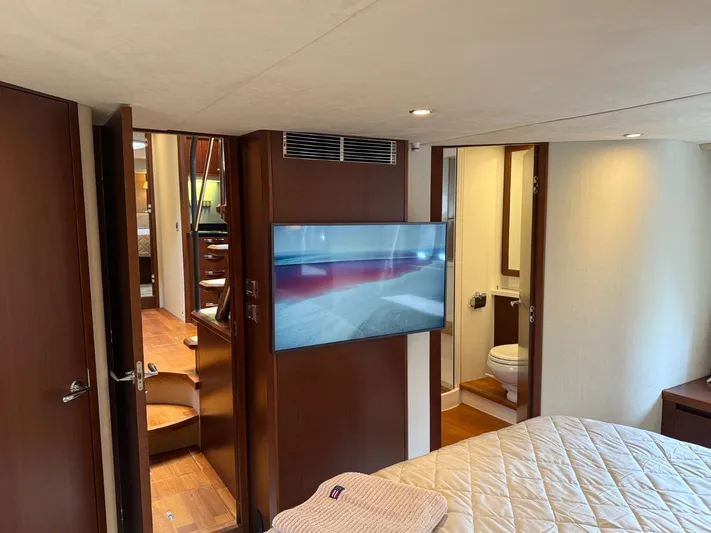  Yacht Photos Pics Luxurious interior of 2009 Princess V65 yacht with bedroom, TV, and bathroom.